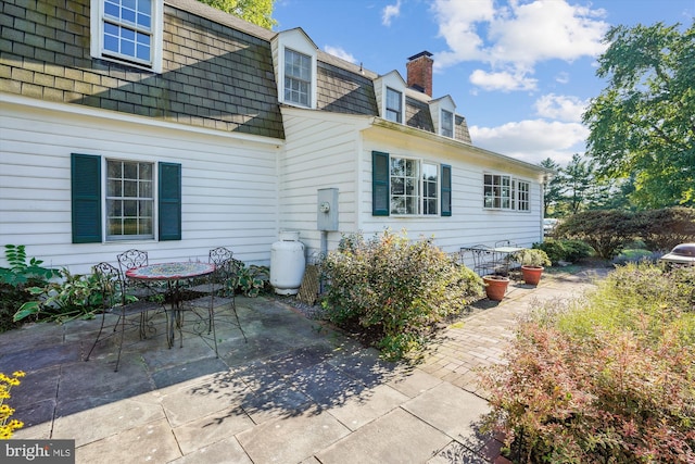 view of property exterior with a patio