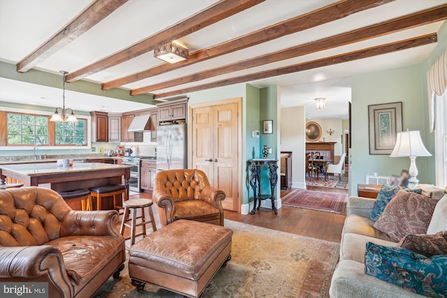 living room featuring dark hardwood / wood-style flooring, a chandelier, and sink