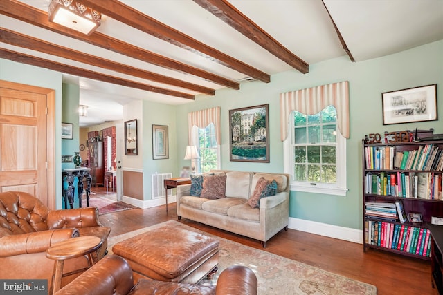 living room featuring beamed ceiling and dark wood-type flooring