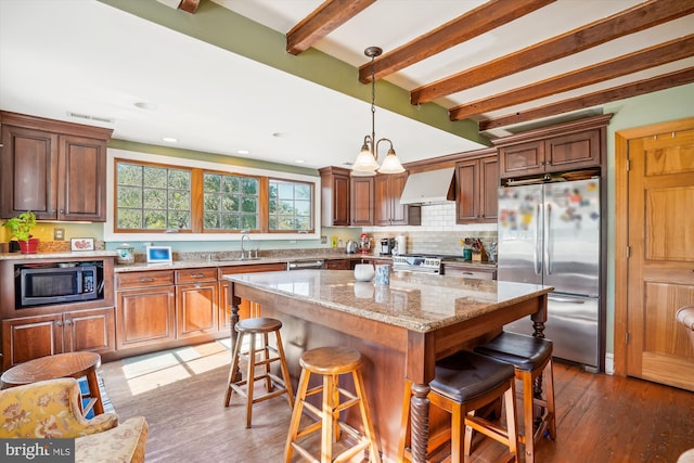 kitchen featuring premium range hood, appliances with stainless steel finishes, dark wood-type flooring, and a center island