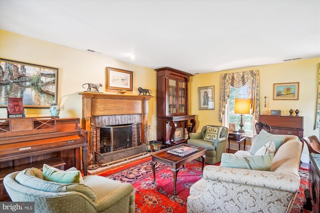 living room with a brick fireplace