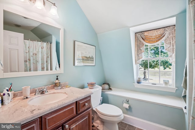 bathroom featuring lofted ceiling, vanity, toilet, and tile patterned floors