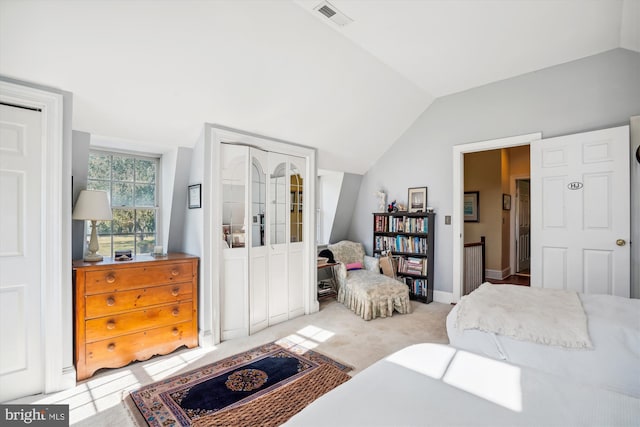 bedroom featuring light carpet and vaulted ceiling