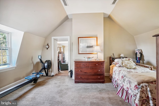 carpeted bedroom featuring lofted ceiling