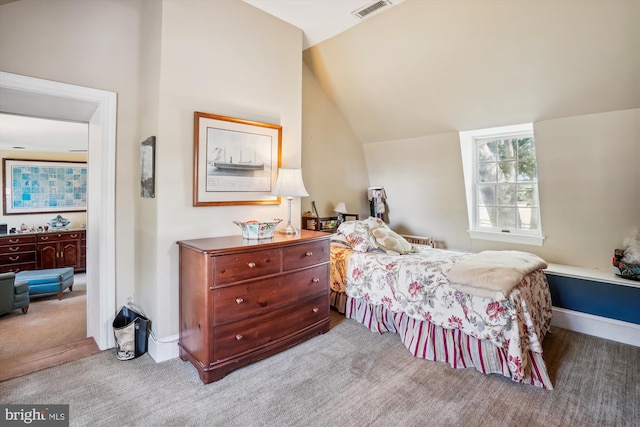 bedroom with lofted ceiling and carpet flooring