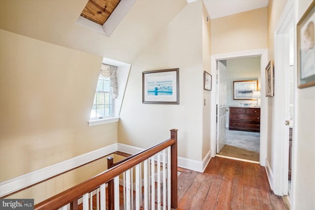 hallway featuring wood-type flooring and vaulted ceiling