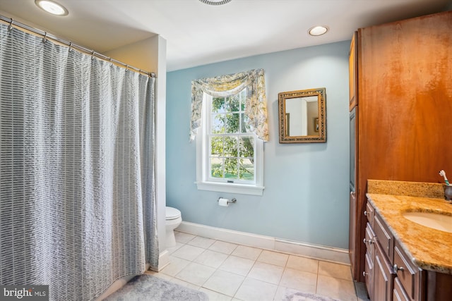 bathroom featuring vanity, tile patterned flooring, and toilet