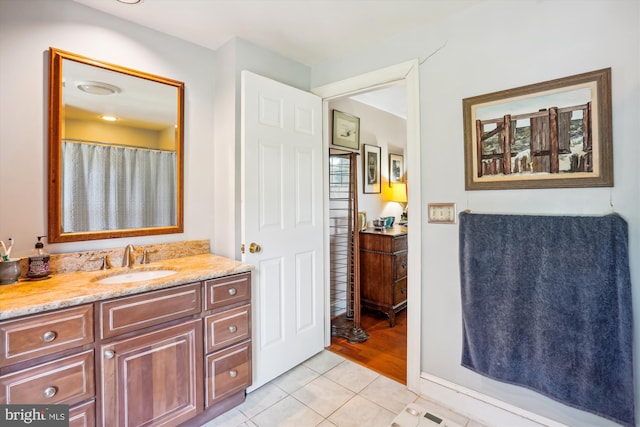 bathroom featuring walk in shower, vanity, and hardwood / wood-style floors