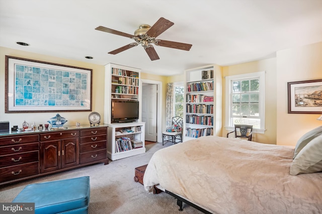 bedroom with light carpet and ceiling fan