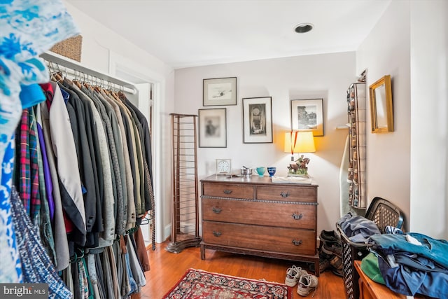 spacious closet featuring dark hardwood / wood-style floors