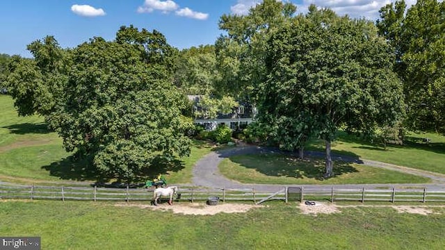 view of home's community featuring a rural view and a yard