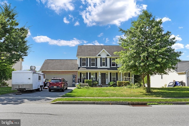 colonial home with a garage and a front lawn