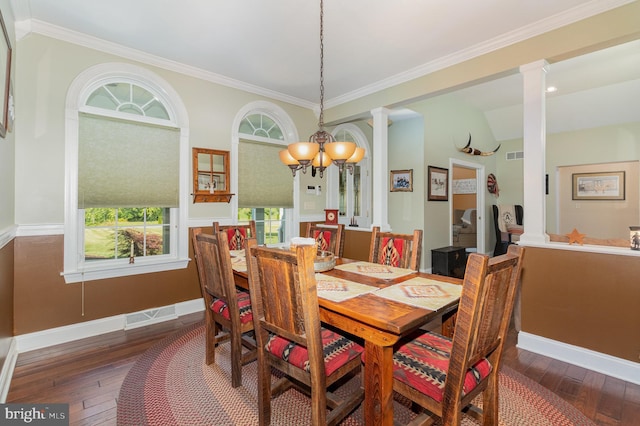 dining space with hardwood / wood-style floors, decorative columns, and baseboards