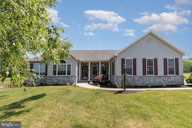 view of front of property with stone siding and a front lawn