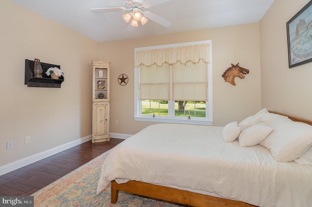 bedroom featuring dark wood finished floors, baseboards, and ceiling fan