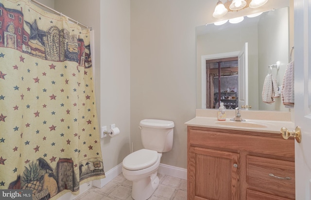 full bath featuring curtained shower, baseboards, vanity, and toilet