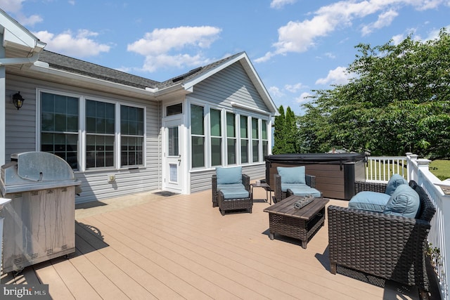 wooden deck with a sunroom, a hot tub, and grilling area