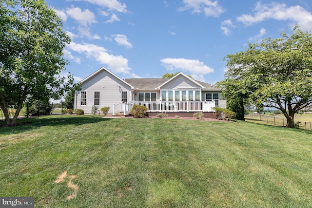 back of house featuring a yard and fence