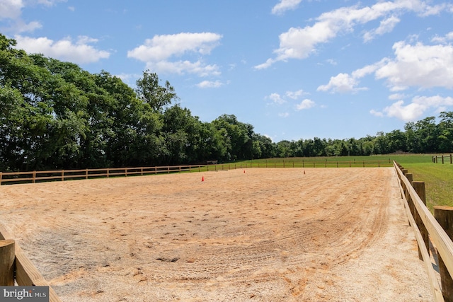 view of yard with an enclosed area and a rural view