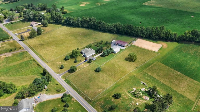 birds eye view of property with a rural view