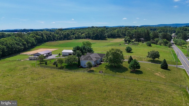 aerial view featuring a view of trees and a rural view