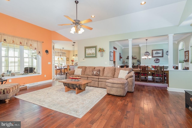 living area with decorative columns, baseboards, lofted ceiling, dark wood-type flooring, and ceiling fan with notable chandelier