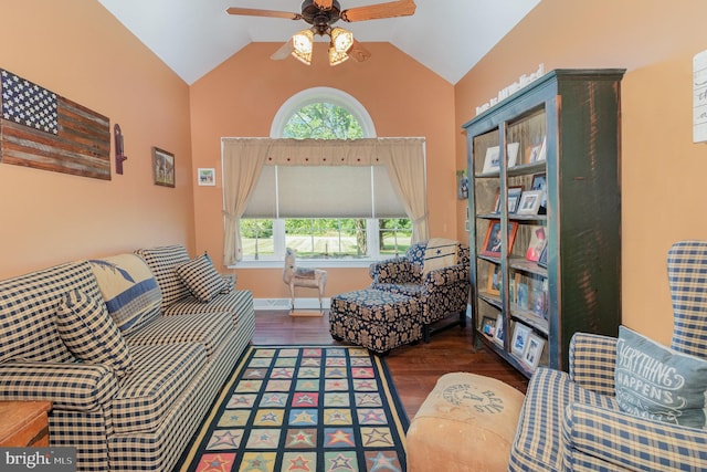 living area featuring a ceiling fan, vaulted ceiling, and wood finished floors