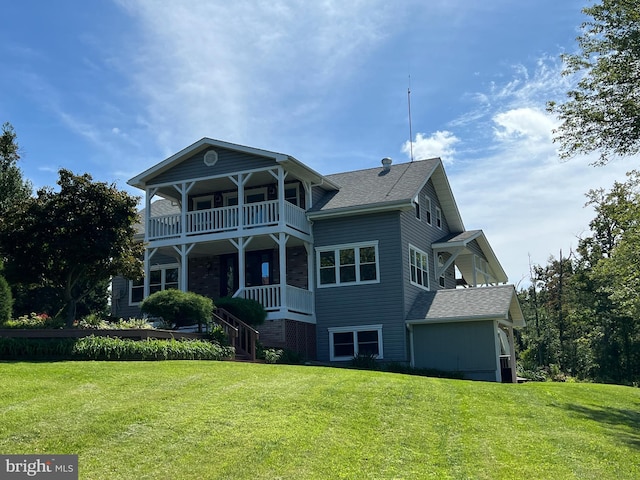 exterior space featuring a lawn and a balcony