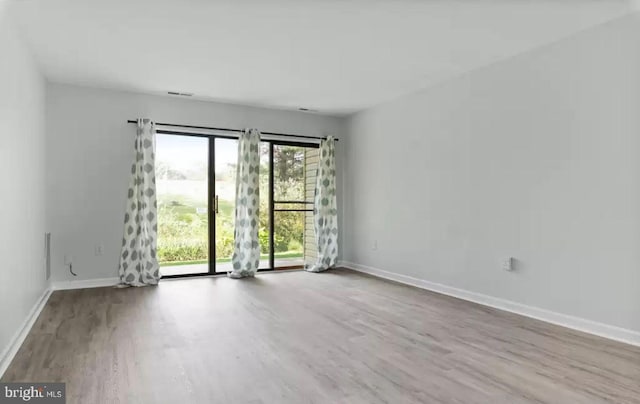 empty room with light hardwood / wood-style floors