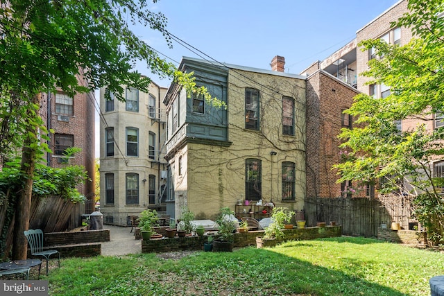 back of house with a lawn