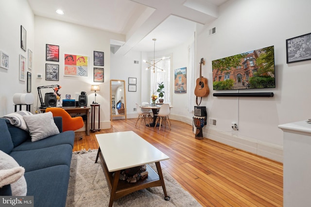 living room featuring light hardwood / wood-style flooring and a chandelier