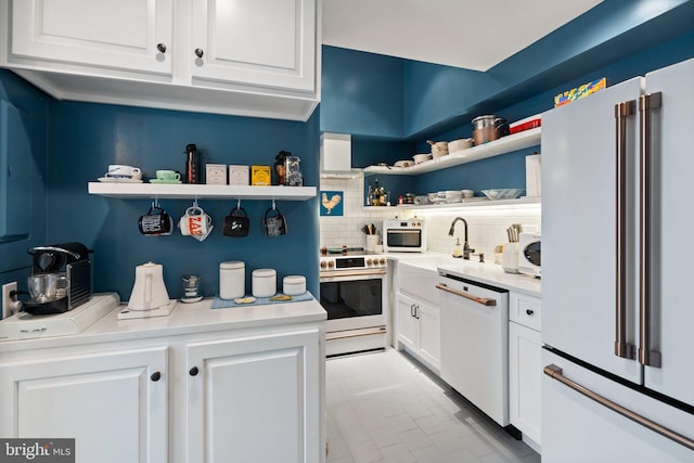 kitchen featuring backsplash, sink, white appliances, and white cabinets