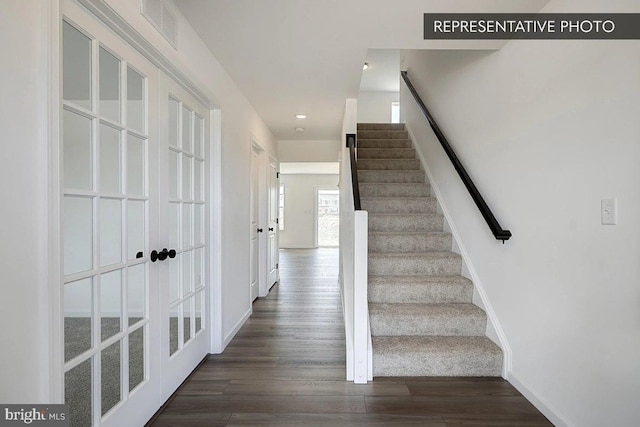 staircase featuring recessed lighting, wood finished floors, visible vents, and baseboards