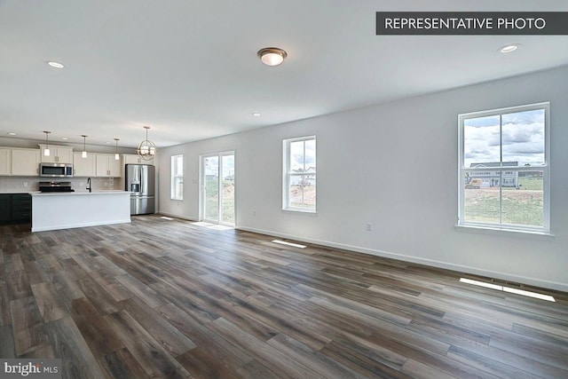 unfurnished living room featuring dark wood-type flooring