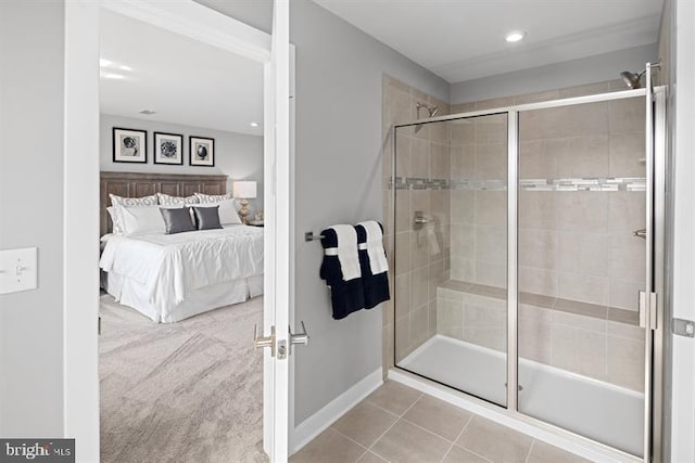 bathroom with an enclosed shower and tile patterned floors