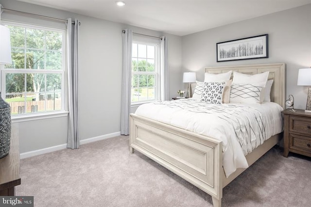 bedroom featuring multiple windows and carpet floors