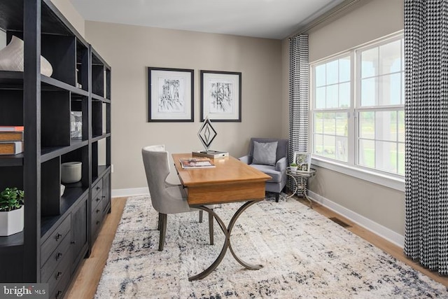 home office with hardwood / wood-style flooring