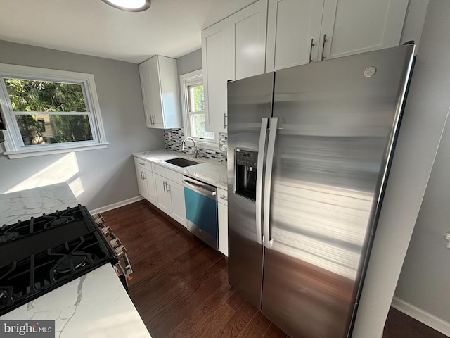 kitchen featuring stainless steel refrigerator with ice dispenser, a sink, tasteful backsplash, dark wood-style floors, and dishwasher