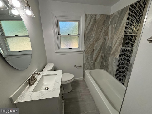 bathroom featuring a healthy amount of sunlight, vanity, and toilet