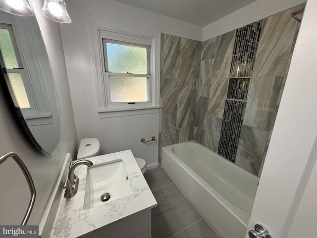 bathroom featuring bathing tub / shower combination, baseboards, toilet, and vanity