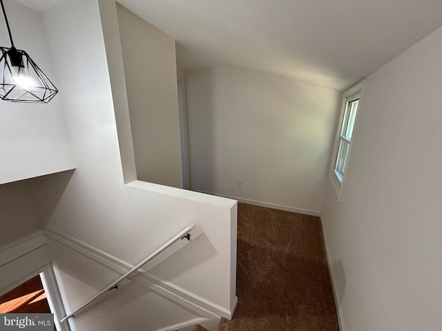 stairway with carpet flooring and baseboards