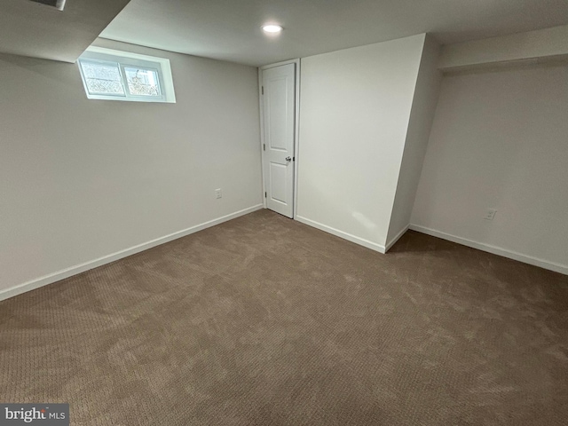 basement with dark colored carpet