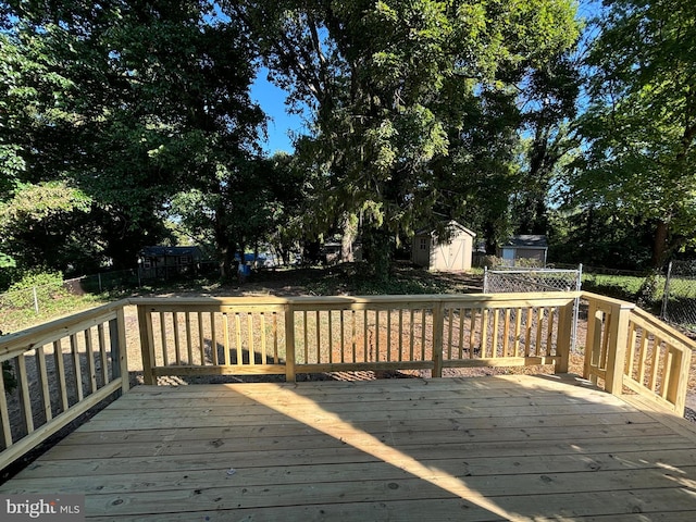 wooden deck with a storage shed