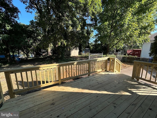 wooden deck with an outdoor structure and a shed