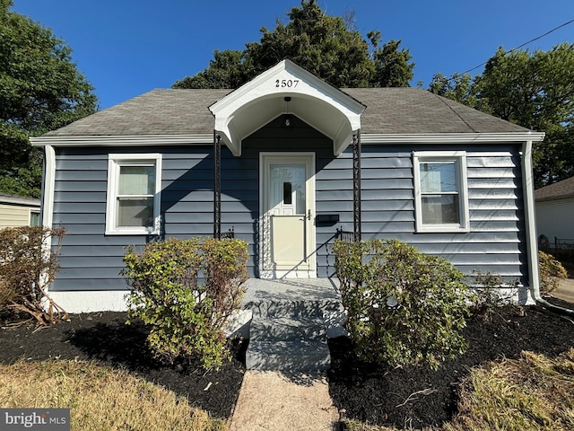 bungalow-style house with a shingled roof