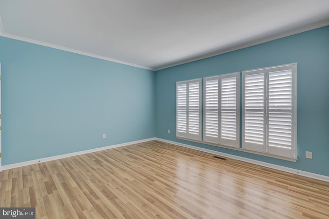 unfurnished room with light hardwood / wood-style floors and crown molding