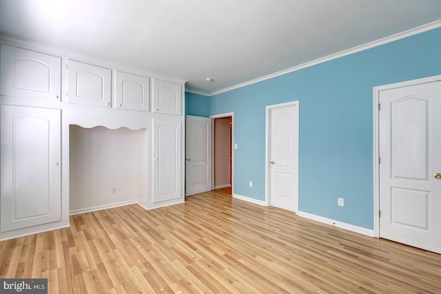 unfurnished bedroom featuring crown molding and light hardwood / wood-style floors