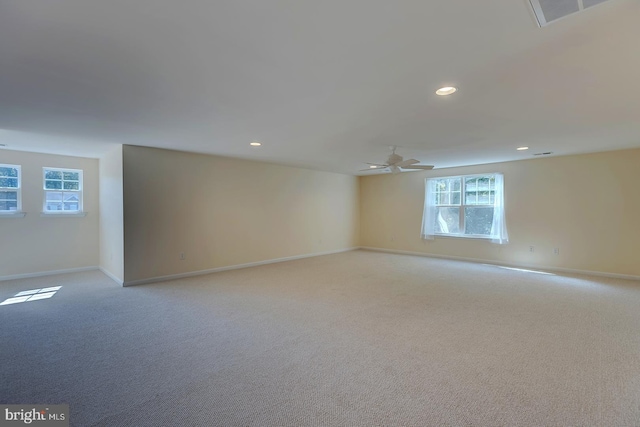 empty room featuring light carpet and ceiling fan