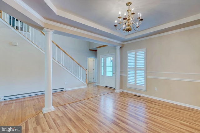 interior space with decorative columns, ornamental molding, a raised ceiling, light hardwood / wood-style floors, and a baseboard heating unit