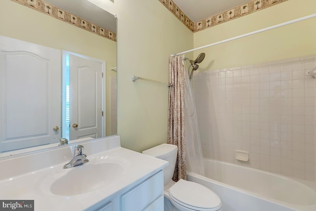 full bathroom with vanity, shower / bath combo with shower curtain, and toilet